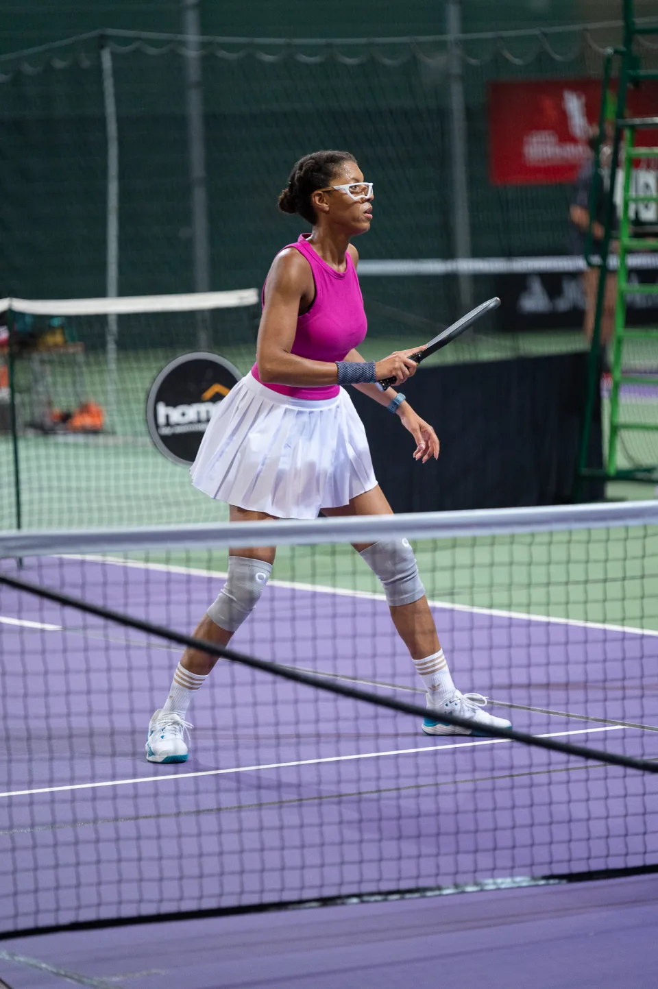 Alicia playing pickleball in a pink top